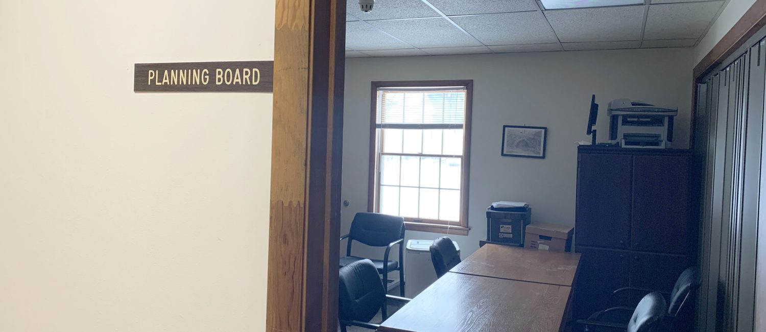 Town of Hamden Planning Board meeting room with brown table and black chairs
